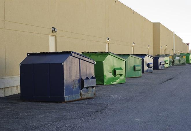 portable, green construction dumpsters serving as a container for scrap materials in Conehatta